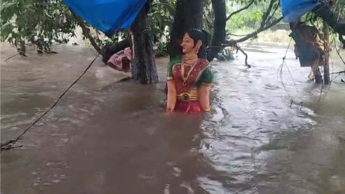 The image shows Sita's statue half-submerged in flood waters in Parnashala on Friday, July 24, 2025.