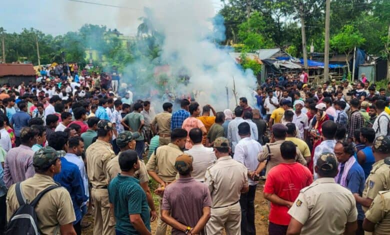 Police personnel stand guard as mortal remains of the college student, who set herself ablaze
