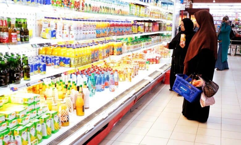 Women shop for sweetened beverages at a UAE supermarket.
