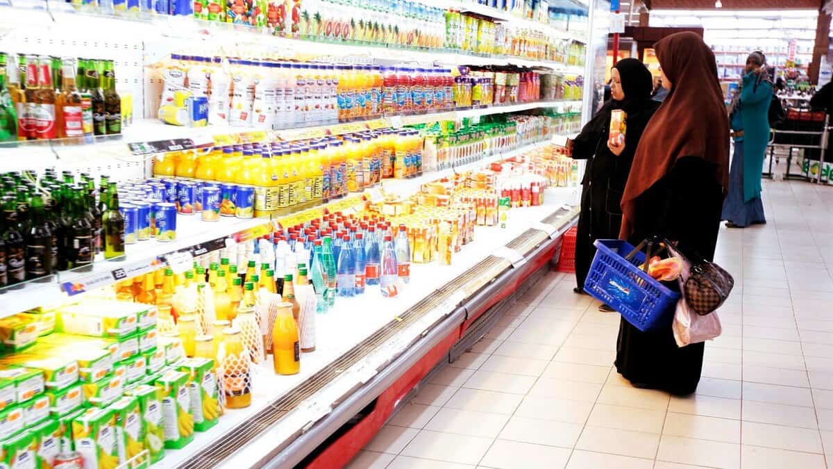 Women shop for sweetened beverages at a UAE supermarket.