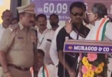 Karnataka CM Siddaramaiah raises his hand on ASP Narayan Baramani during a Congress event in Belgavi