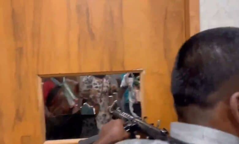 Security personnel of MLC Teenmaar Mallanna firing gunshots at agitating Telangana Jagruthi workers