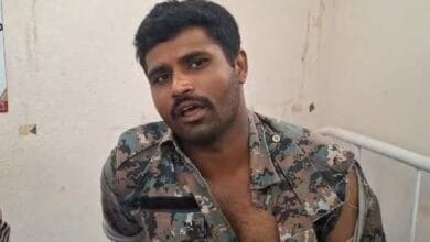 An injured police officer who was attacked by podu Multani farmers in Adilabad on Sunday
