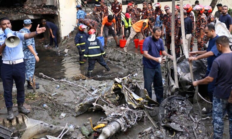 Firemen work at the site of a Bangladesh Air Force training aircraft that crashed into a college campus shortly after takeoff in Dhaka on Monday. (AP/PTI)