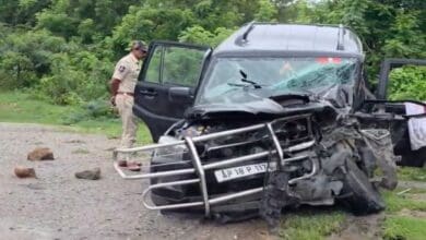 A police man checks the damaged jeep after the accident in Yadadari