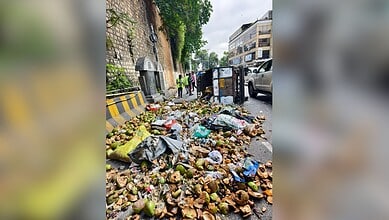Image of overturned garbage trolley at Lower Tank Bund road in Hyderabad.
