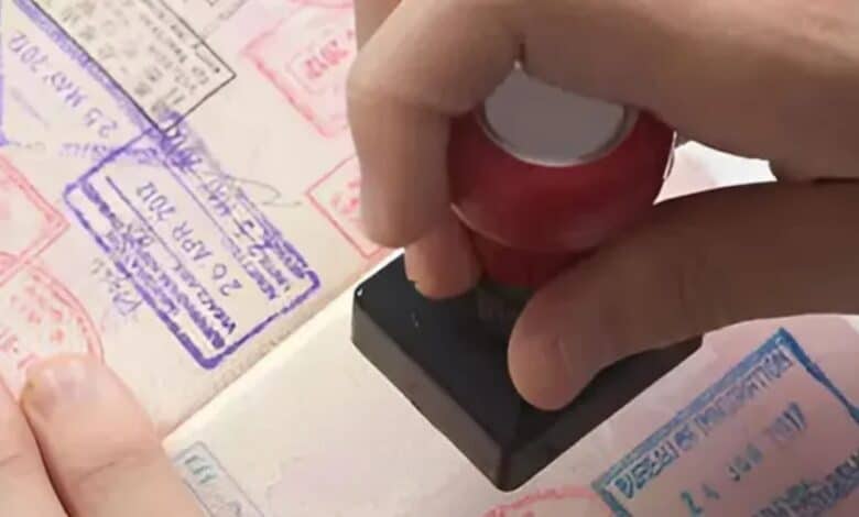 A person is stamping a stamp on a passport.