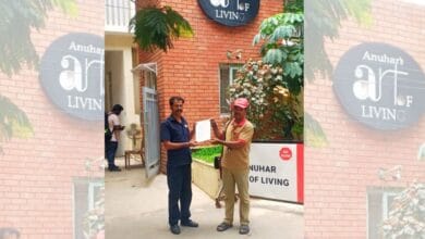 A postman hands over the GHMC order to a security guard at a gated community