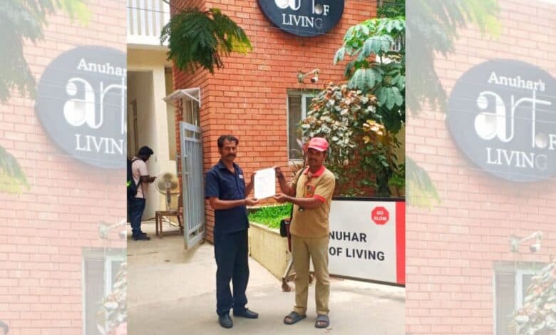 A postman hands over the GHMC order to a security guard at a gated community