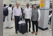 The image of a Augustin Dassayan (centre), the Indian survivor of a Red Sea ship attack, stands at a Saudi airport with Indian consulate staff before flying home.