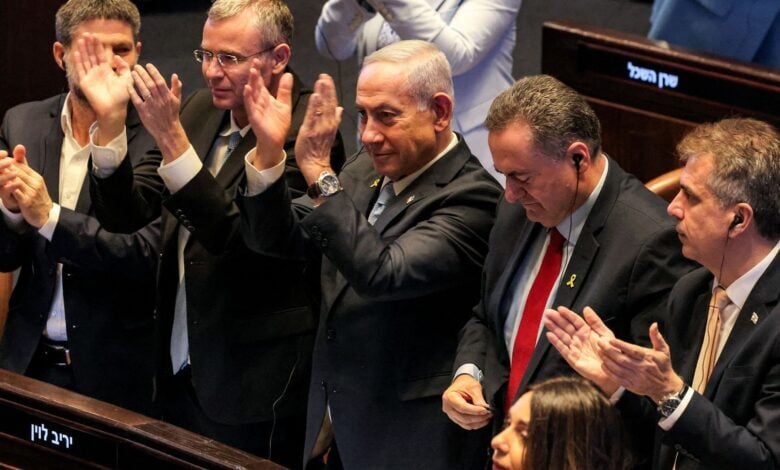 Israel's Finance Minister Bezalel Smotrich, Justice Minister Yariv Levin, Prime Minister Benjamin Netanyahu, Defence Minister Israel Katz, and Energy Minister Eli Cohen applaud during a parliamentary session in Jerusalem, June 11, 2025.