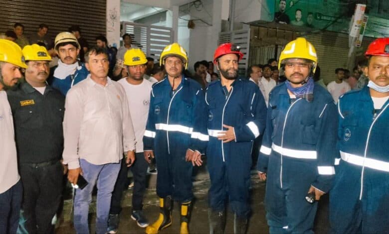 Image of firemen from the Moghalpura fire station after the rescue of residents.