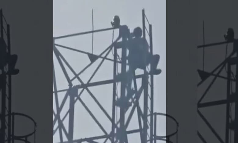 man clims cell tower in Mahabubabad