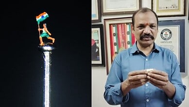 The image shows micro-artist Dr Gurram Dayakar with his new miniature statue carved on a needle.