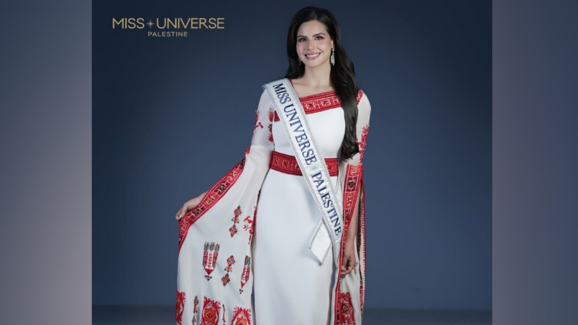 Nadeen Ayoub wearing a traditional Palestinian embroidered dress with the Miss Universe Palestine sash.