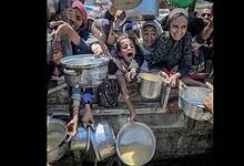People wait for food aid in Gaza