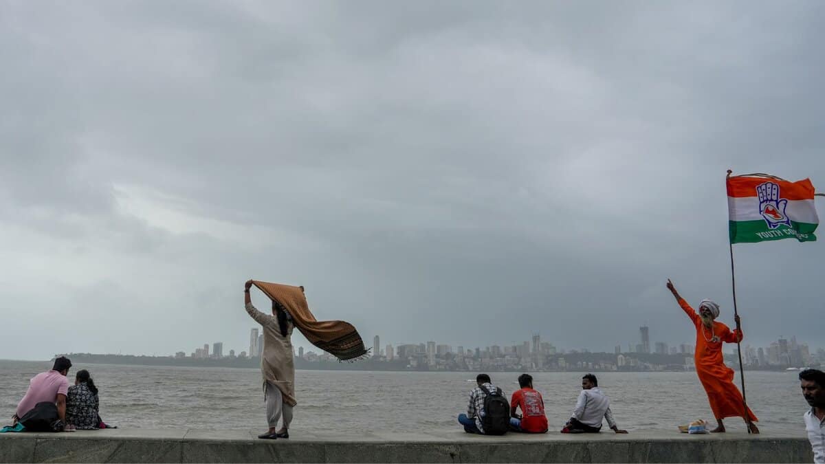 People at Marine Drive as dark clouds hover in the sky, in Mumbai, , Aug. 20, 2025.