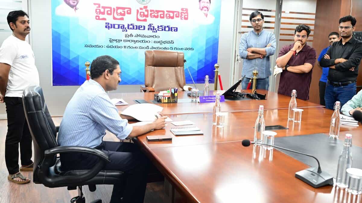 The image shows HYDRAA deputy commissioner N Ashok Kumar accepting petitions from complainants during Prajavani held at Buddha Bhavan in Secunderabad on Monday, August 11, 2025.
