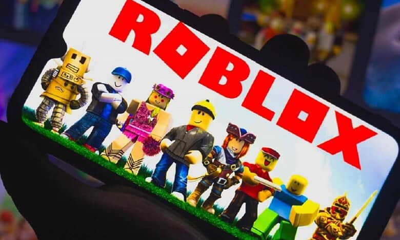 A group of Roblox characters standing on grass, displayed on a phone screen with the "ROBLOX" logo prominently shown.