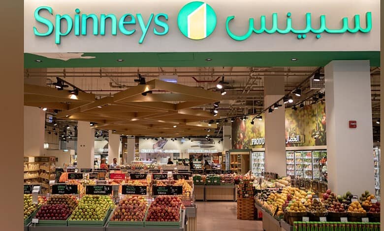 Interior view of a Spinneys supermarket showcasing fresh fruits and groceries.