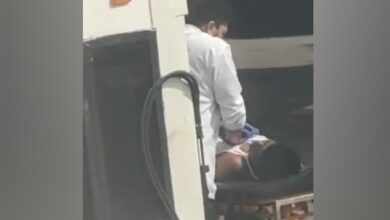A doctor performing CPR on an unconscious migrant worker on a stretcher after an emergency landing at Mumbai airport.