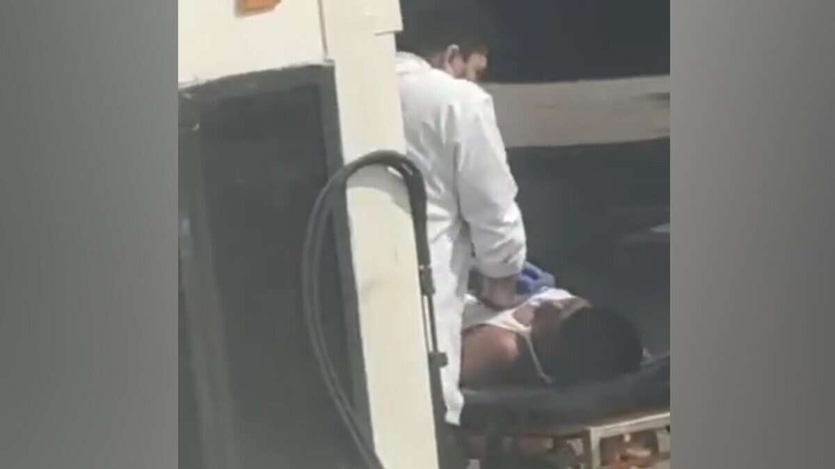 A doctor performing CPR on an unconscious migrant worker on a stretcher after an emergency landing at Mumbai airport.