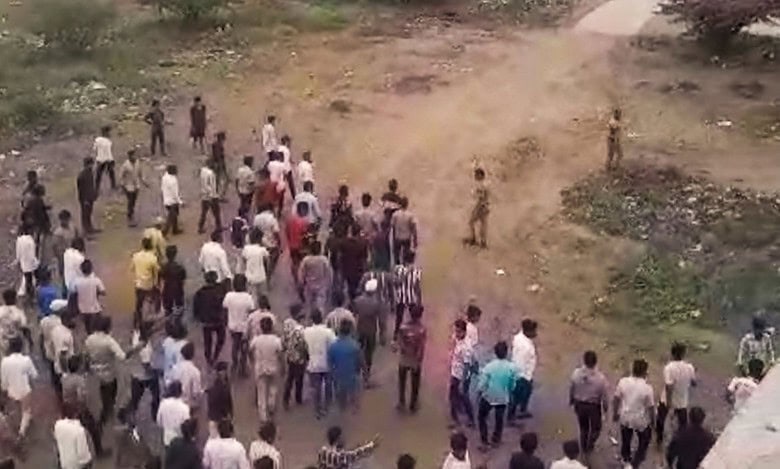People gather after two groups clashed over a social media post in Yavat in Maharashtra's Pune district on Friday.