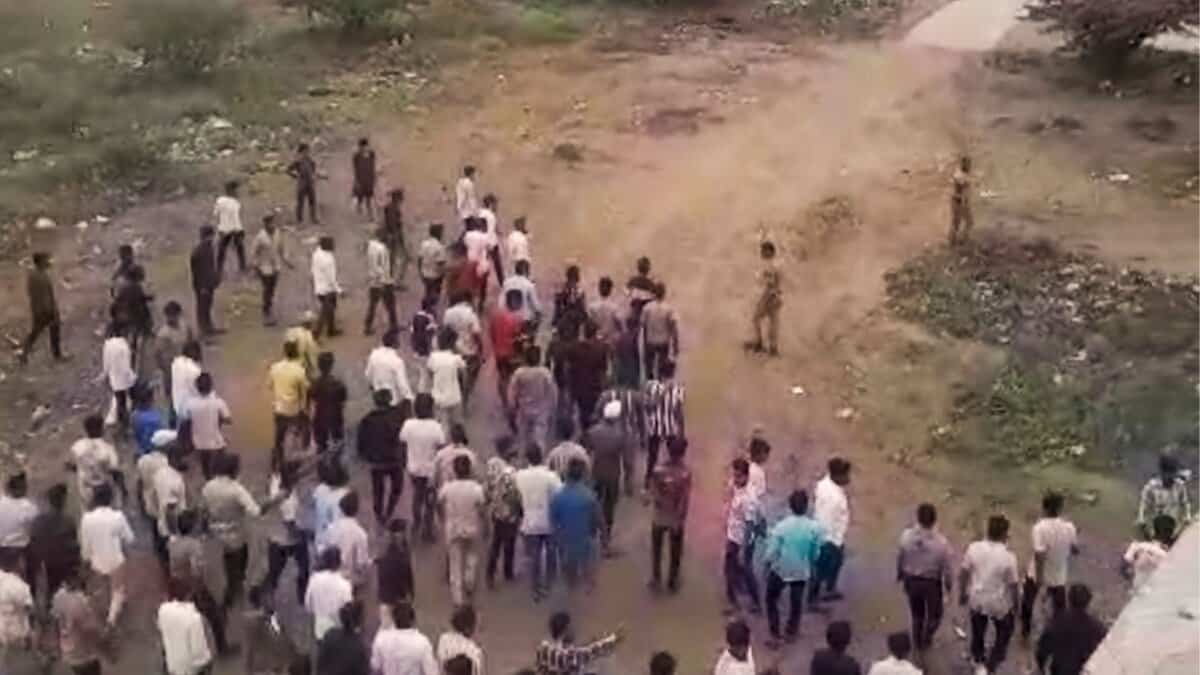 People gather after two groups clashed over a social media post in Yavat in Maharashtra's Pune district on Friday.