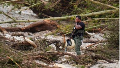 A police officials stands amid debris due floods in Texas