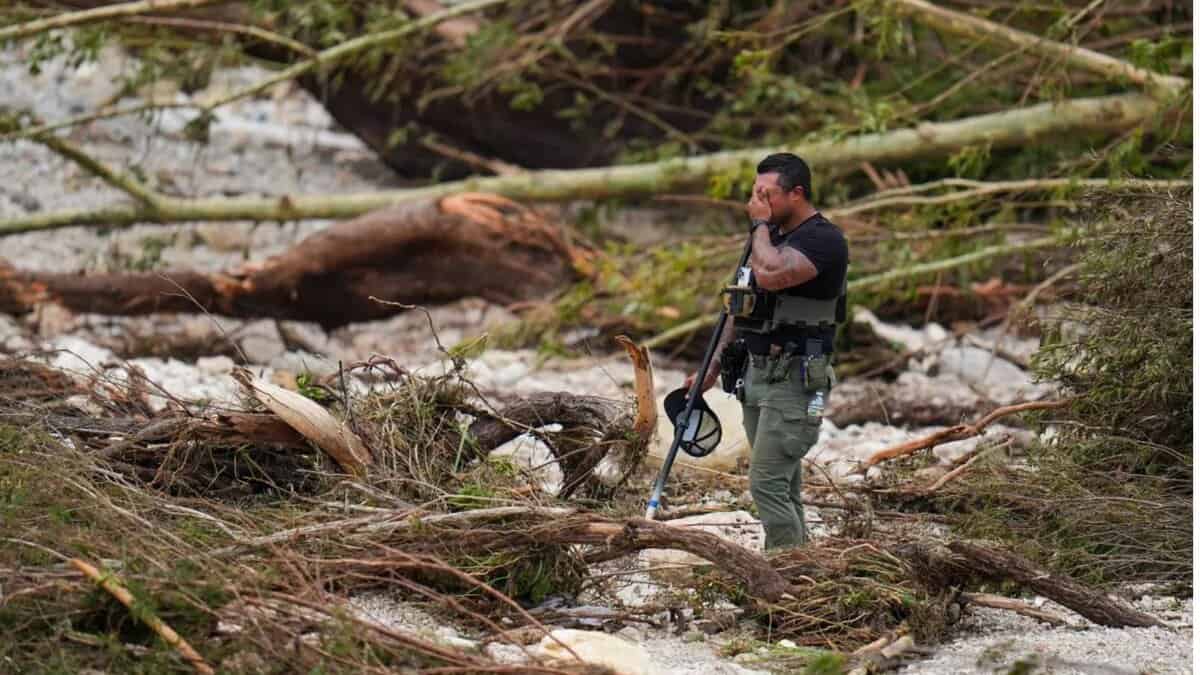 A police officials stands amid debris due floods in Texas