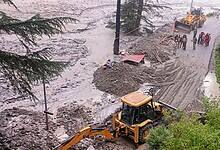 An excavator used to clear debris from a road following flash floods triggered by a cloudburst near Harsil in Uttarkashi district of Uttarakhand on Wednesday (PTI Photo)