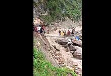 People move across an affected area after a flash flood following a cloudburst in Chashoti area of Kishtwar on Thursday (PTI Photo)