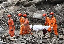 Rescue workers carry a dead body retrieved from the debri. Jammu and Kashmir's Chisoti village has been severly impacted by a cloudburst leaving 61 dead so far (PTI Photo)