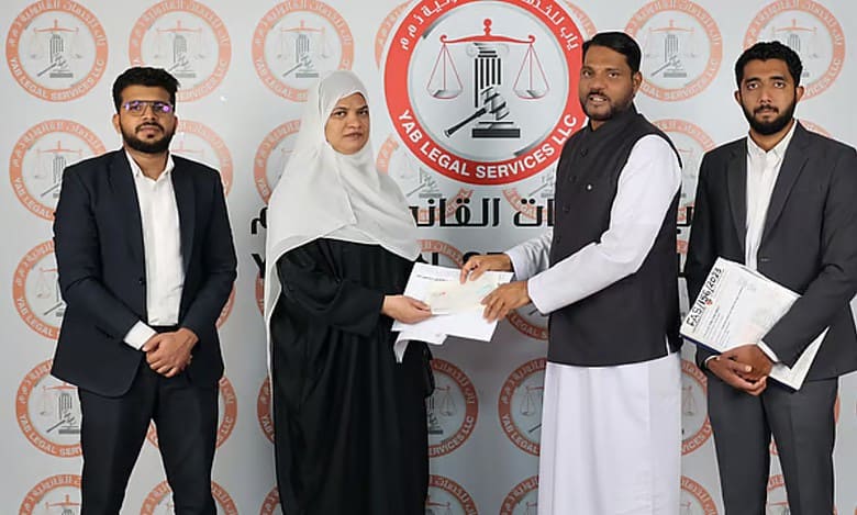 Rehmathbi Mamad Sali receives the compensation for the accident