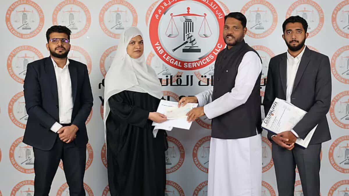 Rehmathbi Mamad Sali receives the compensation for the accident