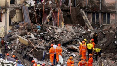 Rescue operation underway after a four-storey unauthorised building collapsed onto adjacent vacant chawl, at Virar on Thursday. (PTI Photo)