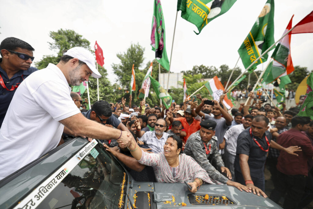 Supporters waving flags during a political rally in India for The Siasat Daily news coverage.