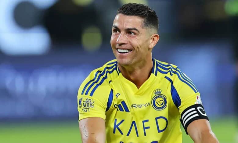 Football star Cristiano Ronaldo in Al Nassr yellow jersey smiling during match.