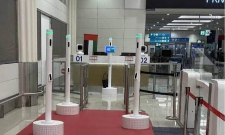 AI-powered passenger corridor at Dubai Airport with multiple biometric scanning stations on a red carpet.