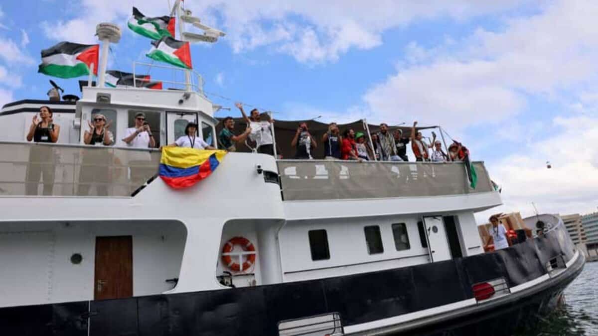 Participants aboard the Global Sumud Flotilla wave Palestinian flags as they depart from the Port of Barcelona to break the Israeli siege on Gaza.