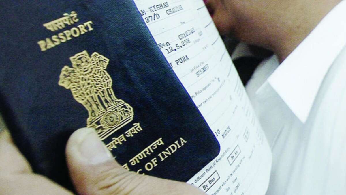 An Indian passport held alongside travel documents.