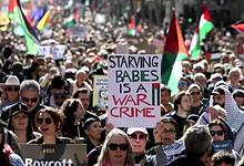 Crowds at a pro-Palestinian rally in Melbourne holding flags and banners on August 24, 2025.
