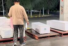 White coffins on pallets prepared for repatriation.