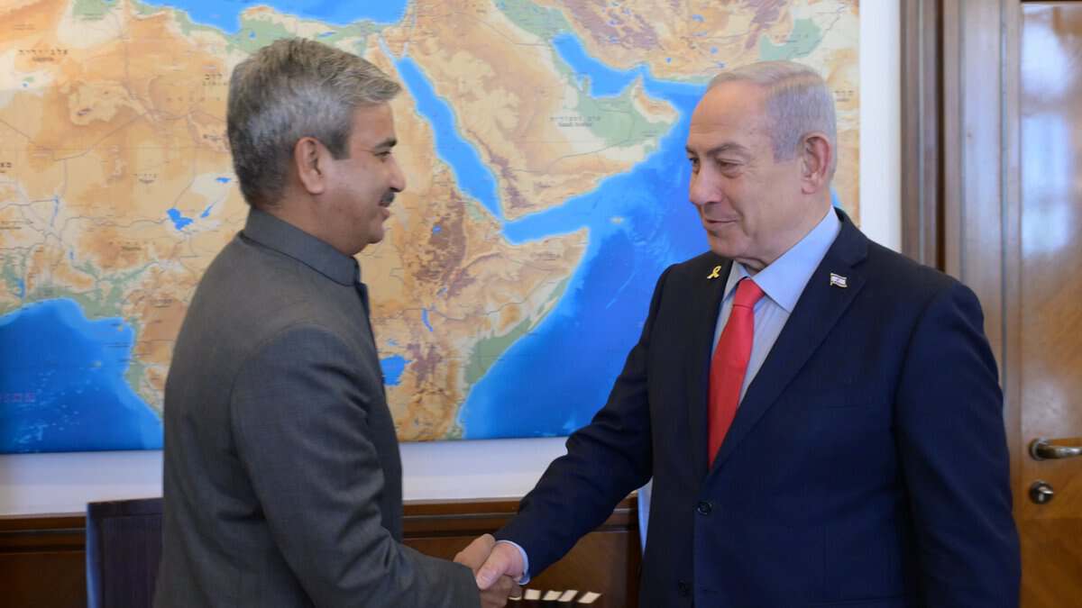 Israeli Prime Minister Benjamin Netanyahu shakes hands with India’s Ambassador to Israel, J P Singh, during a meeting in Jerusalem.