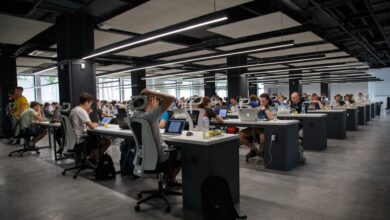 Representative image of a modern open-plan office with employees working on laptops.