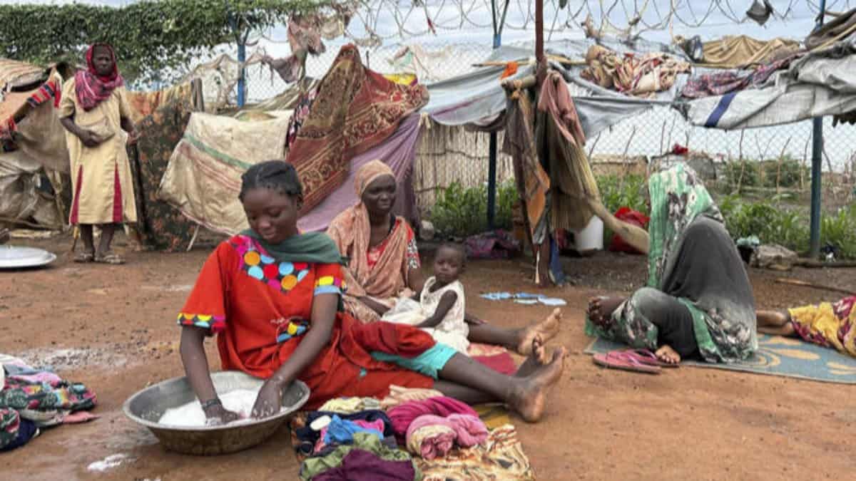 Women wash clothes at Renk transit centre sheltering Sudan war refugees, South Sudan, August 2025.