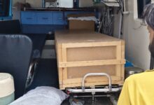 Wooden coffin box inside ambulance carrying mortal remains of Telangana migrant.