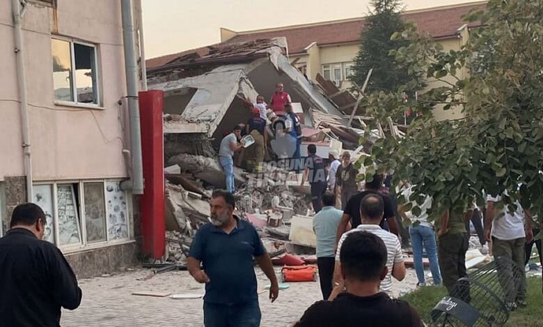 People gather near a collapsed building in Balıkesir, Turkey, after a 6.1-magnitude earthquake.