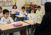 Teacher in black abaya reading a colourful Arabic storybook to young students in a UAE classroom.