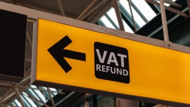 A yellow sign with an arrow pointing to vat return.